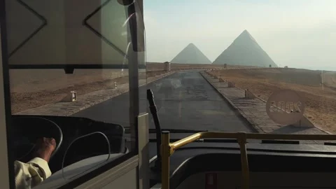 View from driving modern shuttle bus toward the Giza Pyramids highlighting new Stock Footage 341837944