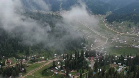 View from drone above clouds of mountain village Stock Footage 236922312