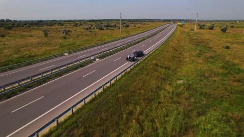 View from a drone, The car carries an inflatable motor boat along the track Video stock 180963779