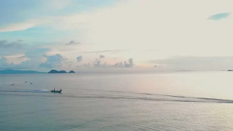 View from drone to endless ocean in the soft dawn light on which the boat floats Stock Footage 232616557