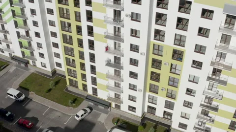 View from a drone of the exterior facade of a high-rise building with offices or 動画素材 142254636