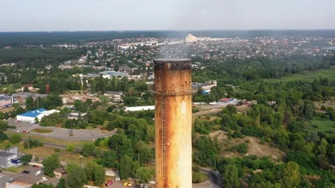 View from a drone flying around industrial plant chimney with smoke emission. Stock Footage 315185763