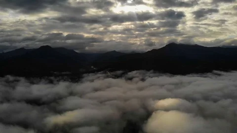 View from a drone flying over a cloud in the morning With the mountainous env Stock Footage 115046881