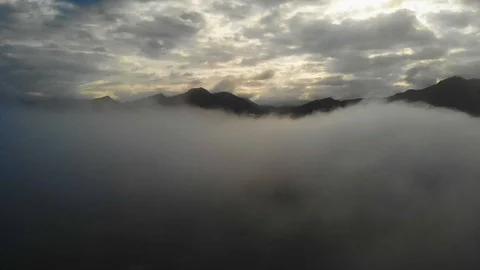 View from a drone flying over a cloud in the morning With the mountainous env Stock Footage 115047481