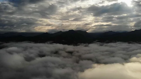 View from a drone flying over a cloud in the morning With the mountainous env Stock Footage 115583698