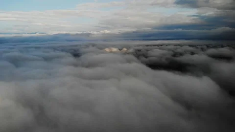 View from a drone flying over a cloud in the morning With the mountainous env Stock Footage 115583700