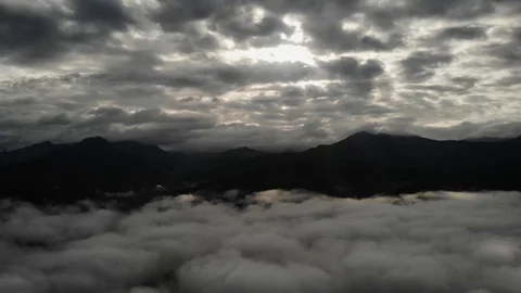 View from a drone flying over a cloud in the morning With the mountainous env Stock Footage 115931484