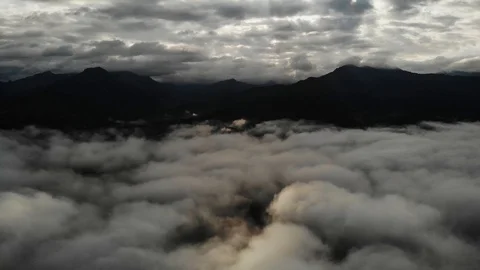 View from a drone flying over a cloud in the morning With the mountainous env Stock Footage 116036576