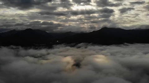 View from a drone flying over a cloud in the morning With the mountainous env Stock Footage 116484754
