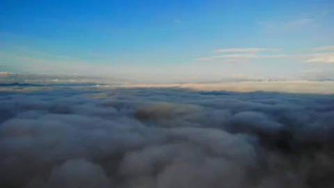 View from a drone flying over a cloud in the morning With the mountainous env Stock Footage 116484875