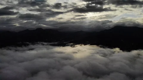 View from a drone flying over a cloud in the morning With the mountainous env Stock Footage 117992203