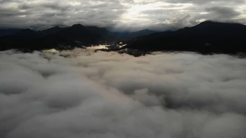 View from a drone flying over a cloud in the morning With the mountainous env Stock Footage 118758009