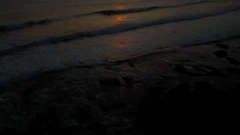 A view from a drone flying over the sea with waves and a view of the fiery su Stock Footage 219122500