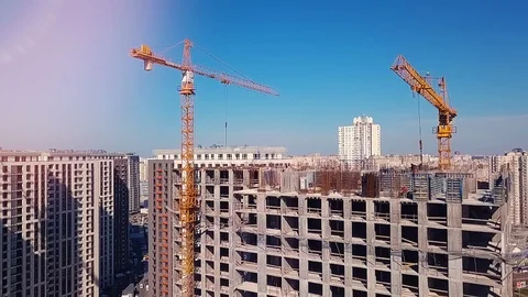 View from the drone going down on a house under construction and builders Stock Footage 126182186