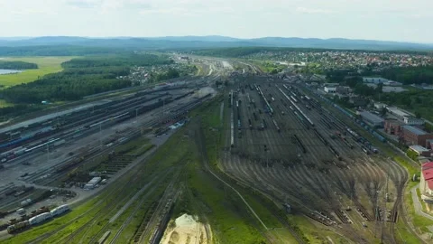 View from the drone on huge rail yard with trains. City outskirts, summer day. Stock Footage 133183532