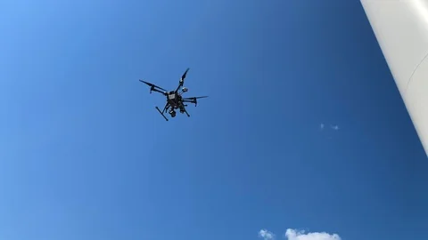 View of a Drone Inspecting a Wind Turbine Stock Footage 115924100