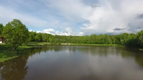 View from the drone. The lake in the forest. Climbing over the forest. Houses in Stock Footage 162179112