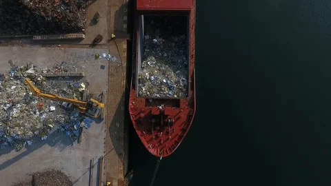 View from a drone, of a load of rubbish with a crane in a boat in Brest Stock Footage 129100166