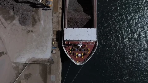 View from a drone, of a load of rubbish with a crane in a boat in Brest Stock Footage 129100171