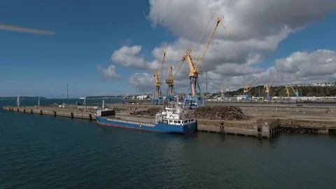 View from a drone, of a load of rubbish with a crane in a boat in Brest Port Stock Footage 129100193