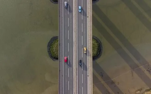 View from a drone looking down on traffic on a road bridge crossing a river Foto stock