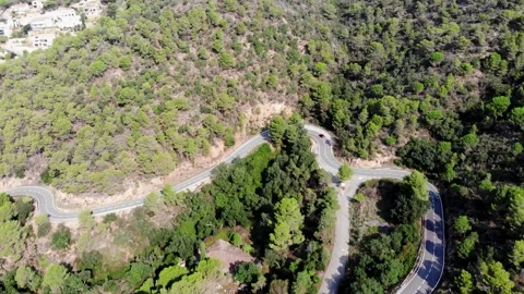 View from a drone on a mountain serpentine in the city of Tossa de Mar Stock Footage 165324940