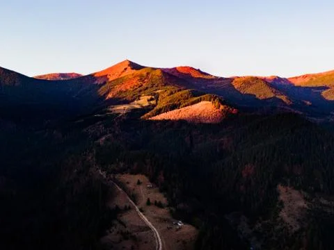 View from a drone on mountains at sunset. Stock Photos