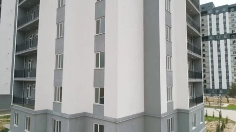 View from the drone panorama from below to the top of a white-gray high-rise Stock Footage 154898695