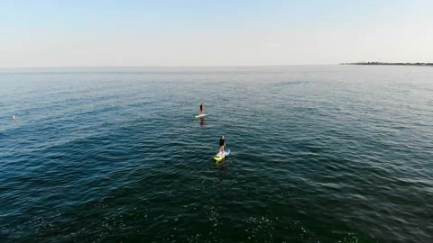 View from a drone people swim on SUP boards in the black sea. Stock Footage 169092374