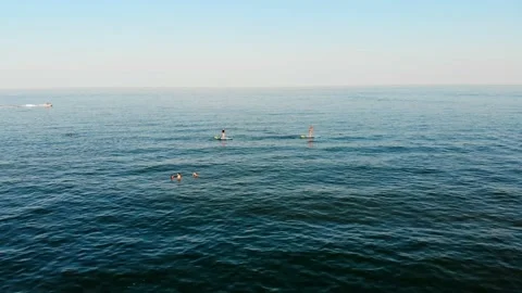 View from a drone people swim on SUP boards in the black sea Stock Footage 169092402