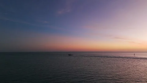 View from drone on picturesque evening sunset with distance motorboat gracefully Stock Footage 264521930