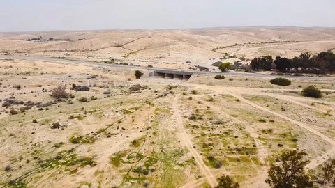 View from drone on the road with a bridge in desert Stock Footage 125331574