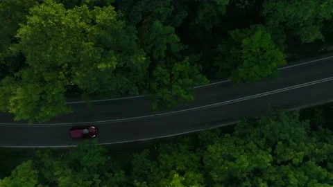 The view from the drone to the road through the forest against the background Stock Footage 197129792