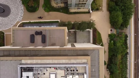 View from a drone on the roof of multi-storey buildings surrounded by trees. Vídeo Stock 201876034