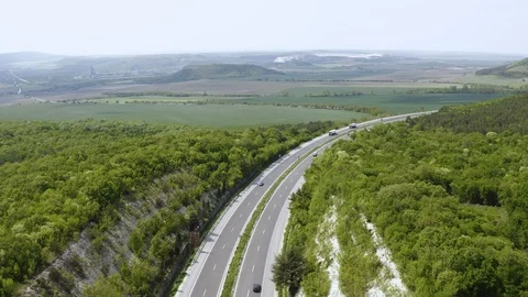 View drone slide on panorama of mountainous terrain and motorway cars travel Stock Footage 108167209