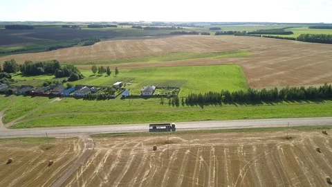 View from the drone to a small village that is next to the field of cereals Stock Footage 79435392