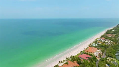 View from drone on stunning coastline with beachfront homes and dwellings Stock Footage 247702590