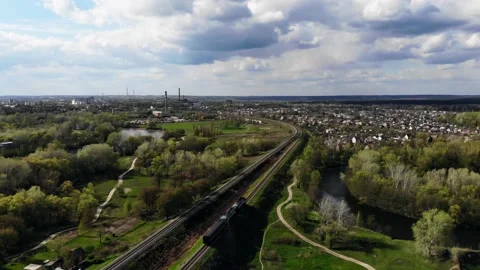View from the drone to the train that is going by rail in a picturesque place Stock Footage 154293030