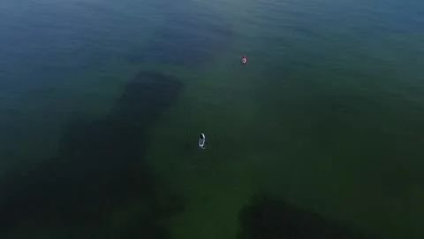 View from a drone to a two guys floating on SUP boards Stock Footage 163205494