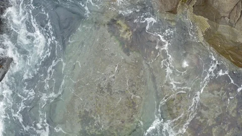 View from the drone, water rolls over stones Stock Footage 122720861