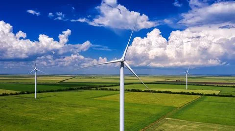 View from Drone at windpark and windmill farm. Wind turbine from aerial view. Stock Photos