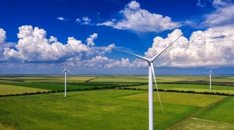 View from Drone at windpark and windmill farm. Wind turbine from aerial view. Stock Photos