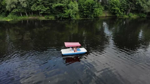 View from a drone young people float on a catamaran on the river Видео 156206608