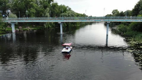View from a drone young people float on a catamaran on the river Stock Footage 156206625