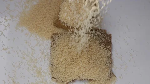 View of dropping rice over a brown Bag Video stock 147694340