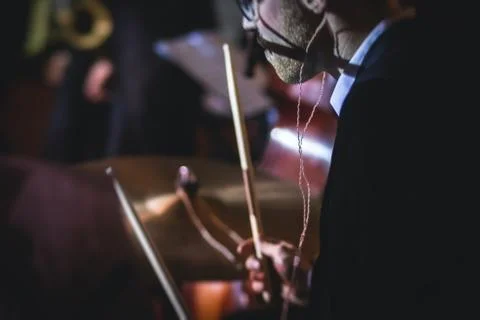 View of drum set kit on a stage during jazz rock show performance, with band  Stock Photos