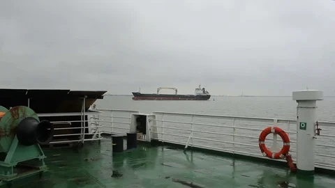 View of the dry cargo ship going by the sea from the ferry Stock Footage 79413556