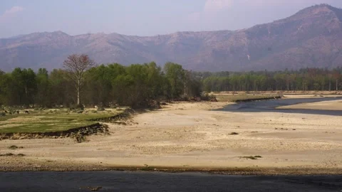 View of a dry riverbed and distant mountains, Nepal. Video stock 335604146