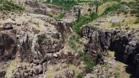 View of dry volcanic canyon slopes and ancient basalt pillars in Kazakhstan Видео 338066151
