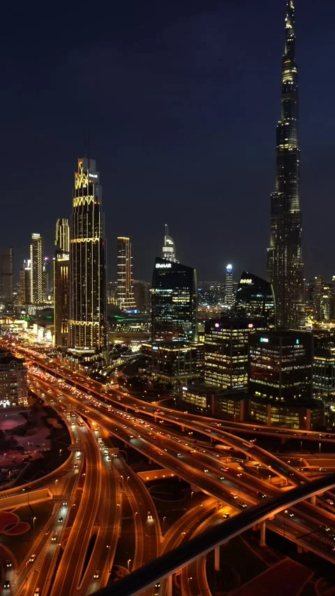 A view of the Dubai skyline and the junction of the roads in the valley At night Stock Footage 241950712